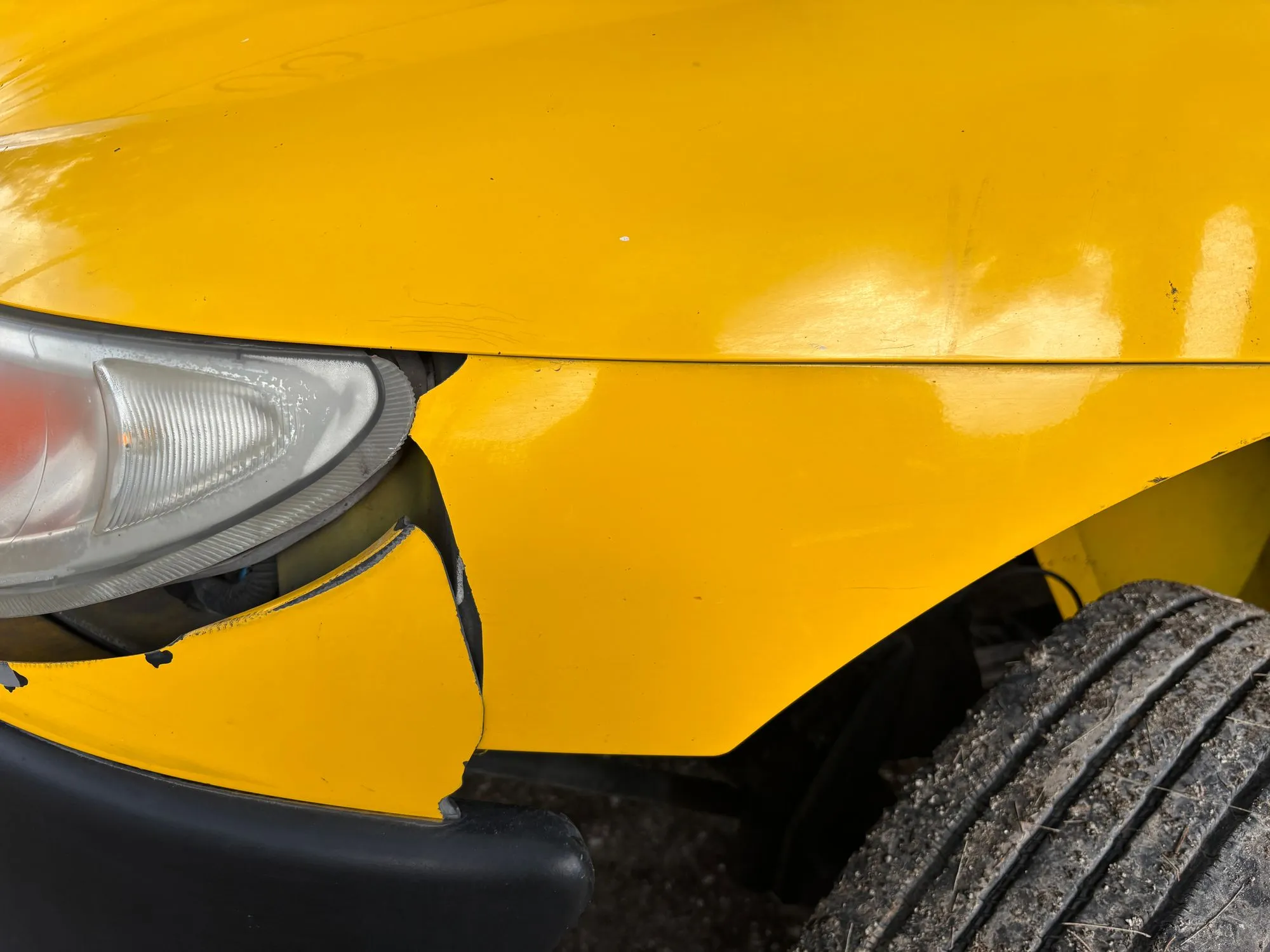 Evidence of previous collision repair — panel work, body filler, or overspray — found during a pre-purchase inspection