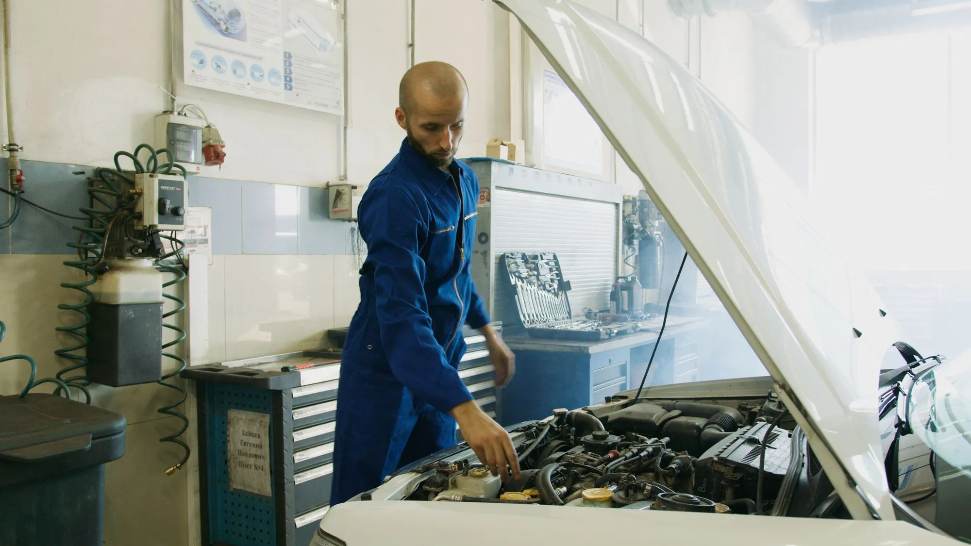 Auto Ally inspector examining a used pickup truck before purchase in Northern Utah